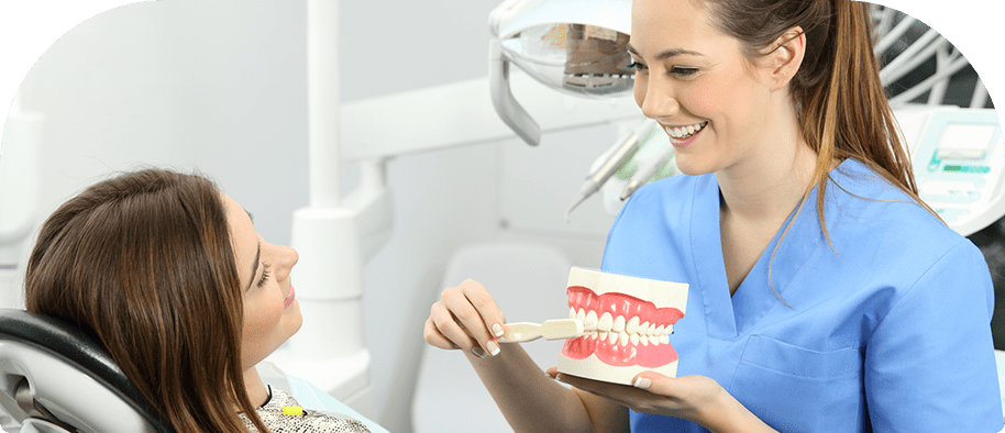 Hygienist Showing Patient How to Brush teeth