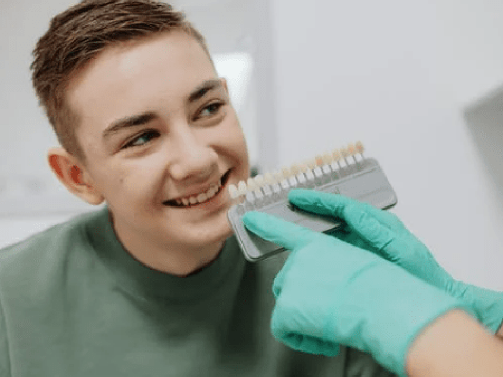 Dentist showing patient different shades of teeth options