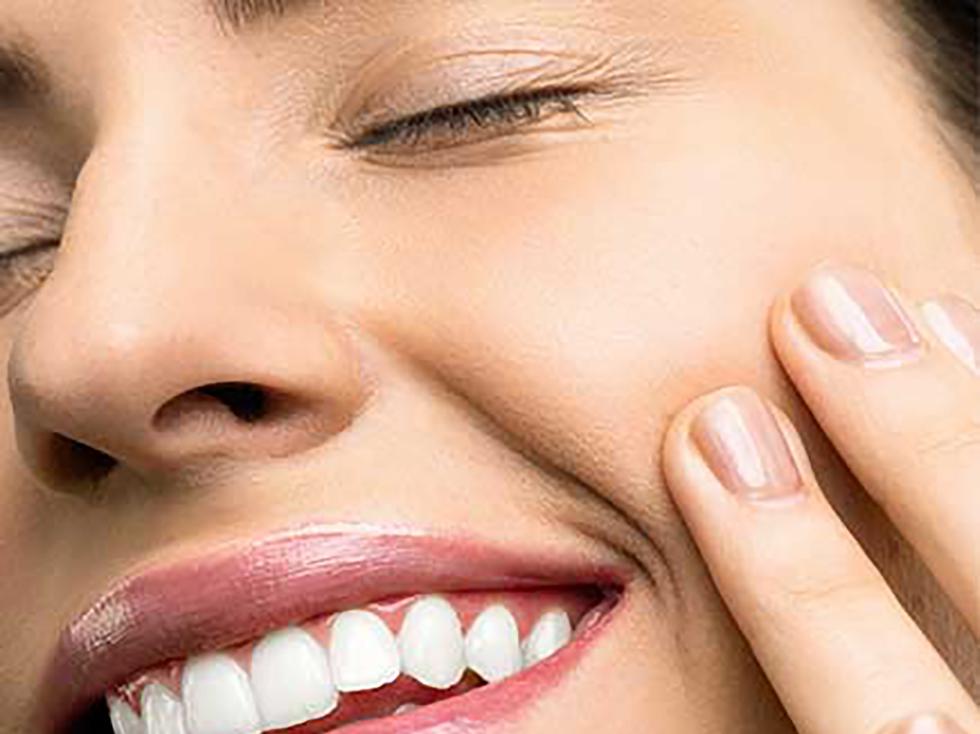 Woman smiling touching the side of her face